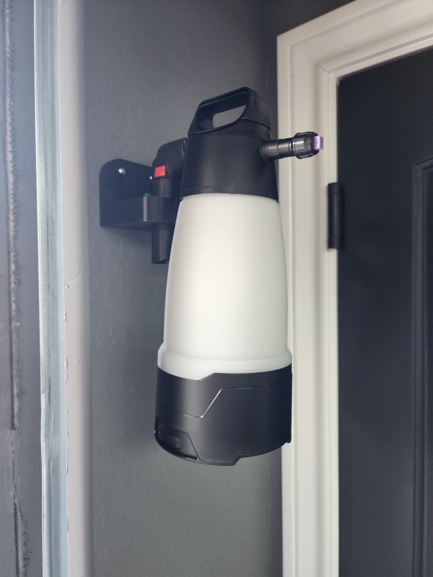 IK Sprayer bottle in wall mount on detailing workbench
